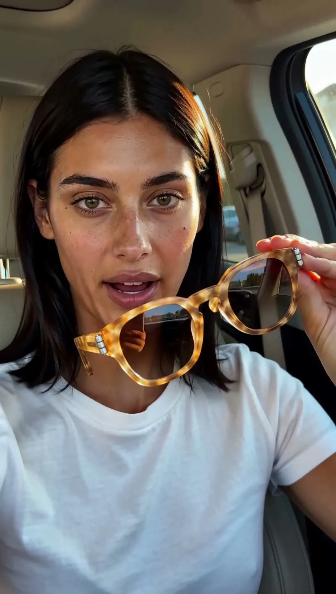 Synthetic talent Miranda Calder sitting in a car interior during a 1088×1920 local video generation test