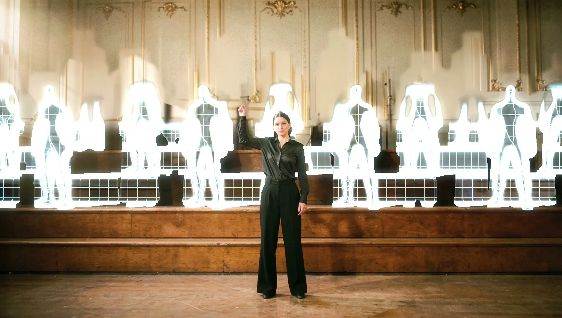 AI frame on a concert stage: a woman in black raises one hand as a choir behind her appears as glowing white hologram figures on the risers